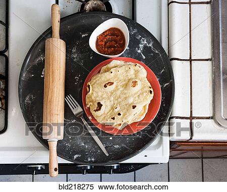 Stock Photography - Platter of tortillas, salsa and rolling pin. Fotosearch