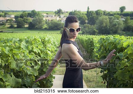 Stock Photography - Playful Caucasian woman in vineyard. Fotosearch