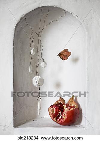 Pomegranate and decorations near moth in wall alcove View Large Photo Image Picture - Pomegranate and decorations near moth in wall alcove. Fotosearch