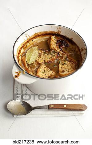 Stock Photo - Pot of stewed meat with spoon. Fotosearch