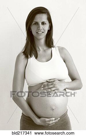 Pregnant Caucasian woman holding her belly View Large Photo Image Stock Image - Pregnant Caucasian woman holding her belly. Fotosearch