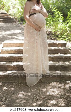 Pregnant Caucasian woman standing on hillside steps View Large Photo Image Stock Image - Pregnant Caucasian woman standing on hillside steps. Fotosearch
