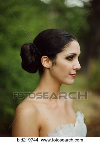 Profile view of bride wearing wedding dress outdoors View Large Photo Image Picture - Profile view of bride wearing wedding dress outdoors. Fotosearch