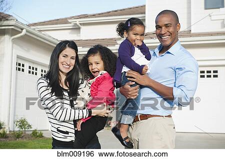 Proud parents and daughter standing in driveway View Large Photo Image Stock Photograph - Proud parents and daughter standing in driveway. Fotosearch