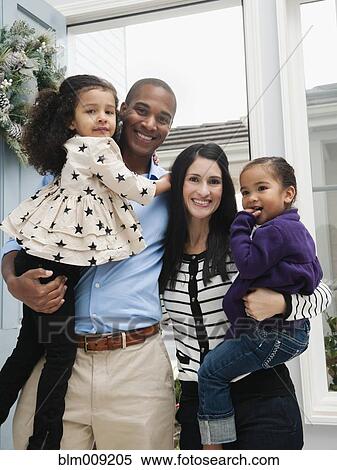 Proud parents holding daughters View Large Photo Image Stock Photography - Proud parents holding daughters. Fotosearch