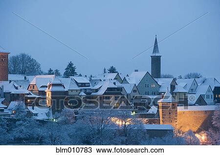 Stock Image - Quaint, snow covered village at night. Fotosearch