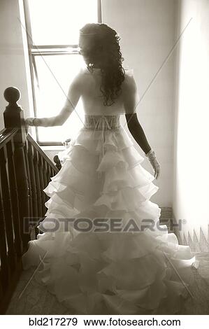 Rear view of bride walking down staircase View Large Photo Image Stock Photo - Rear view of bride walking down staircase. Fotosearch