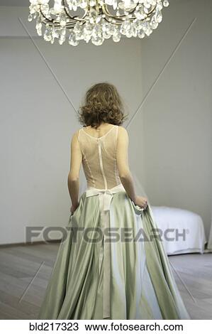 Stock Image - Rear view of bride wearing wedding dress. Fotosearch