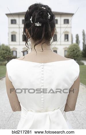 Rear view of Caucasian bride in wedding gown View Large Photo Image Stock Image - Rear view of Caucasian bride in wedding gown. Fotosearch