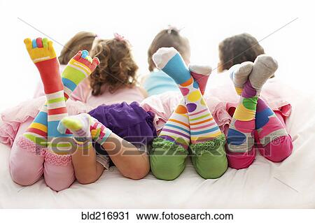 Stock Image - Rear view of girls wearing colorful socks. Fotosearch