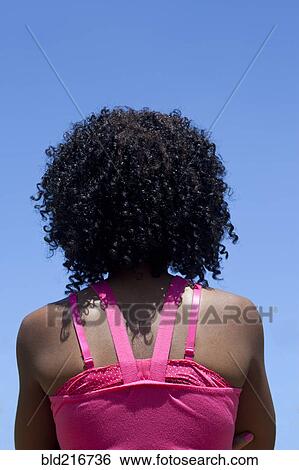 Stock Photograph - Rear view of woman with curly hair. Fotosearch
