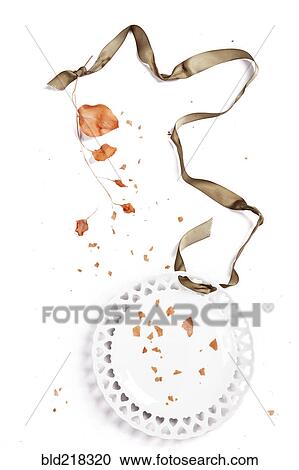Stock Image - Ribbon, scattered autumn leaves and plate. Fotosearch
