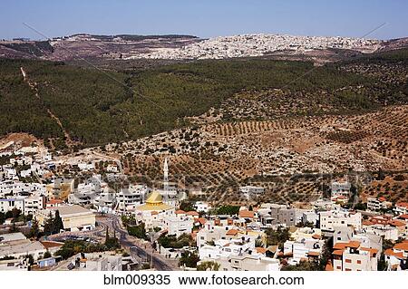 Stock Photography - Rolling hills and rooftops of city. Fotosearch
