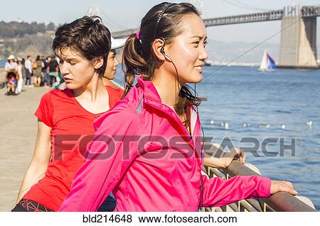 Stock Photo - Runner stretching at waterfront, San Francisco, California, United States. Fotosearch