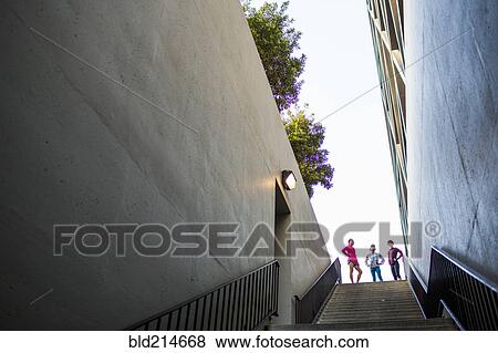 Stock Photo - Runners standing at top of urban staircase. Fotosearch