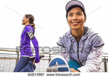 Runners stretching at waterfront View Large Photo Image Stock Image - Runners stretching at waterfront. Fotosearch