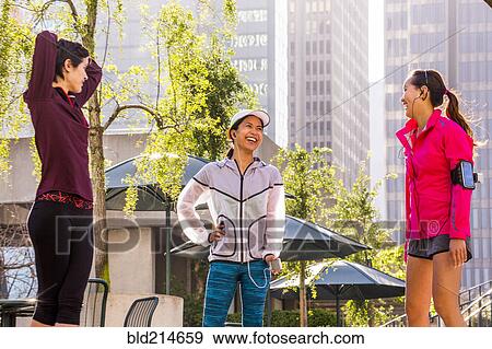 Runners stretching in urban park View Large Photo Image Stock Photo - Runners stretching in urban park. Fotosearch