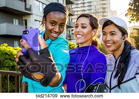 Runners taking selfie on in city View Large Photo Image Stock Photo - Runners taking selfie on in city. Fotosearch