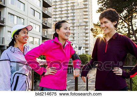 Stock Photography - Runners talking in city. Fotosearch