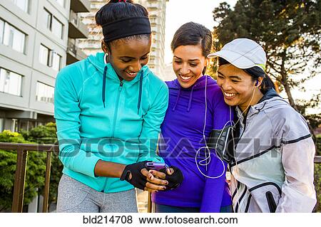 Runners using cell phone in city View Large Photo Image Stock Photo - Runners using cell phone in city. Fotosearch