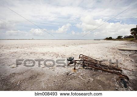 Rusted shopping cart buried in sand View Large Photo Image Stock Image - Rusted shopping cart buried in sand. Fotosearch