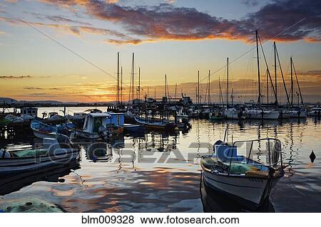 Sailboats moored in marina at sunset View Large Photo Image Stock Photo - Sailboats moored in marina at sunset. Fotosearch