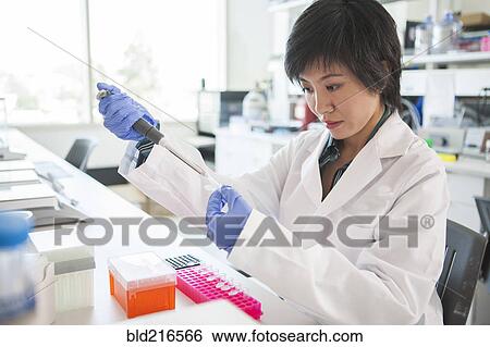 Scientist pipetting liquid into test tube in laboratory View Large Photo Image Stock Photograph - Scientist pipetting liquid into test tube in laboratory. Fotosearch