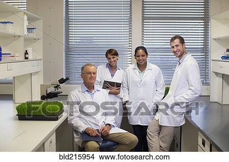Scientists smiling in laboratory View Large Photo Image Picture - Scientists smiling in laboratory. Fotosearch