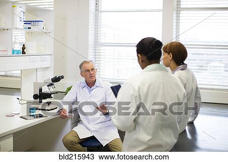 Stock Image - Scientists talking in laboratory. Fotosearch