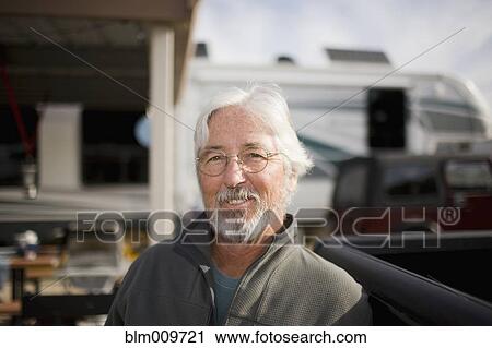Senior Caucasian man sitting outside motor home View Large Photo Image Stock Image - Senior Caucasian man sitting outside motor home. Fotosearch
