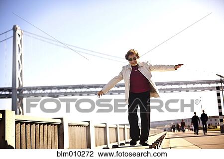 Senior Hispanic woman walking on urban boardwalk View Large Photo Image Stock Image - Senior Hispanic woman walking on urban boardwalk. Fotosearch