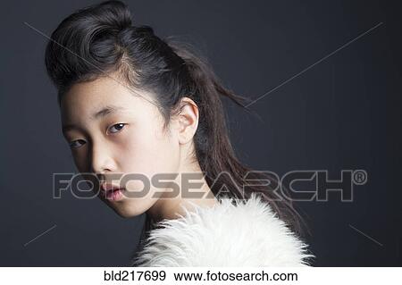 Stock Photo - Serious Asian girl wearing fur shawl. Fotosearch
