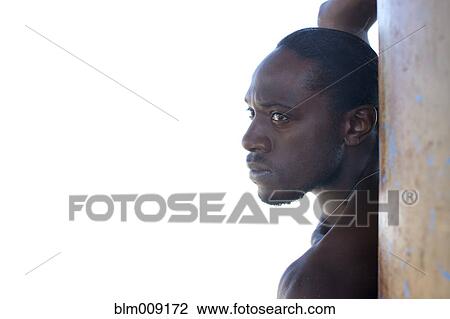 Serious Black man standing outdoors View Large Photo Image Stock Image - Serious Black man standing outdoors. Fotosearch