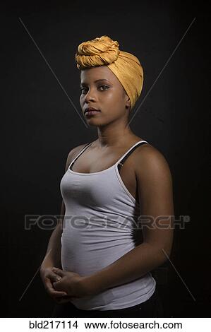 Picture - Serious Black woman wearing headwrap. Fotosearch