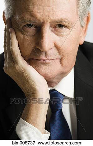 Stock Photo - Serious Caucasian businessman with head in hands. Fotosearch