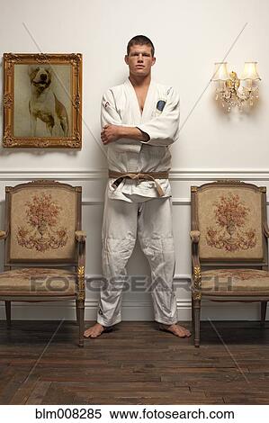 Serious Caucasian man in martial arts uniform standing in elegant room View Large Photo Image Stock Photography - Serious Caucasian man in martial arts uniform standing in elegant room. Fotosearch