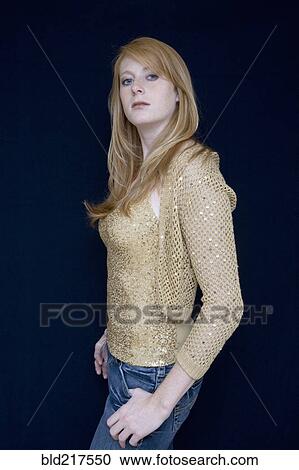 Stock Image - Serious Caucasian standing with hands in pockets. Fotosearch
