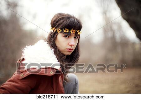 Stock Image - Serious Caucasian woman wearing flower crown. Fotosearch