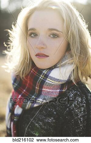 Stock Image - Serious Caucasian woman wearing plaid scarf. Fotosearch