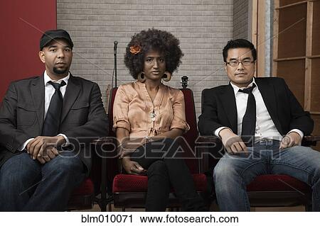 Serious friends sitting together View Large Photo Image Stock Image - Serious friends sitting together. Fotosearch