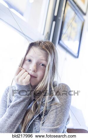 Serious girl resting chin in hand View Large Photo Image Stock Photograph - Serious girl resting chin in hand. Fotosearch