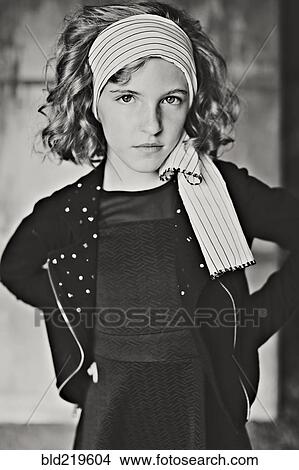Serious girl standing with hands on hips View Large Photo Image Picture - Serious girl standing with hands on hips. Fotosearch