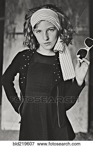 Serious girl standing with hands on hips View Large Photo Image Stock Photo - Serious girl standing with hands on hips. Fotosearch