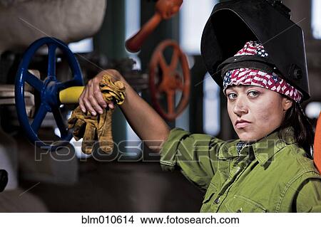 Picture - Serious Hispanic welder. Fotosearch
