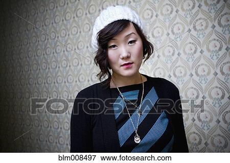 Serious Korean woman in knit cap View Large Photo Image Stock Photo - Serious Korean woman in knit cap. Fotosearch