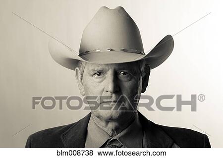 Stock Photo - Serious man wearing cowboy hat. Fotosearch