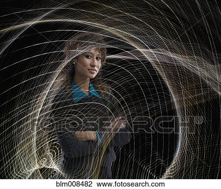 Serious mixed race businesswoman surrounded by swirling lines View Large Photo Image Stock Image - Serious mixed race businesswoman surrounded by swirling lines. Fotosearch