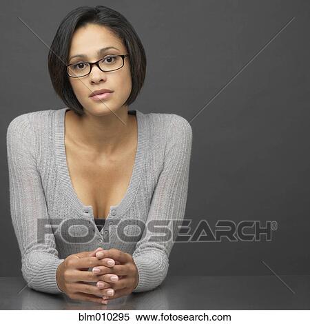 Serious mixed race woman with hands clasped View Large Photo Image Stock Photography - Serious mixed race woman with hands clasped. Fotosearch