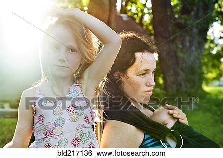 Stock Photograph - Serious mother and children outdoors. Fotosearch