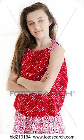 Serious teenage girl standing with arms crossed View Large Photo Image Picture - Serious teenage girl standing with arms crossed. Fotosearch